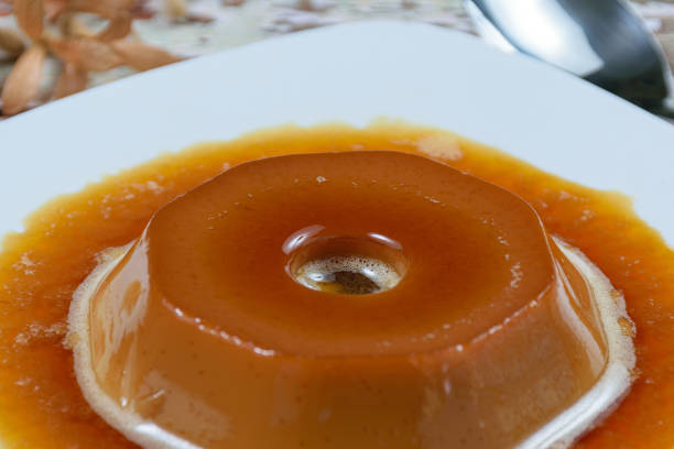 istock Closeup on the central circle of dulce de leche pudding with caramel sauce, selective focus. A traditional Brazilian sweet. 1309847271