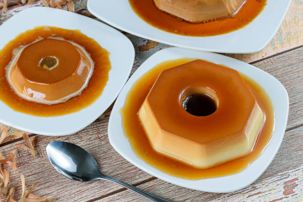 istock Condensed milk pudding with caramel syrup, surrounded by other puddings, spoon and flying seeds (Triplaris amaricana). Traditional Brazilian sweet. 1309847821