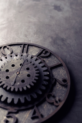 Old black wooden clock with gears.
