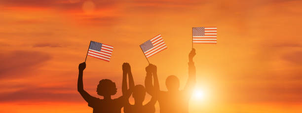 istock USA flag on sky background. American holidays 1309853530