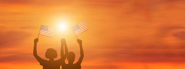 istock USA flag on sky background. American holidays 1309853586
