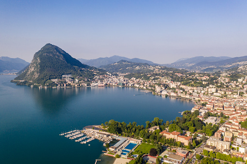 Aerial view of Beautiful Lugano lake and Lugano City on a hill in Southern Switzerland, Ticino Canton.