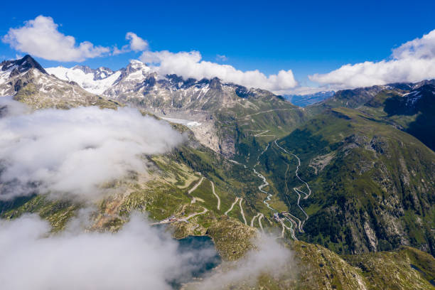 Aerial view of the Grimsel and Furka mountain pass in the alps between cantons of Bern, Valais and Uri in Switzerland on a sunny summer day Aerial view of the Grimsel and Furka mountain pass in the alps between cantons of Bern, Valais and Uri in Switzerland on a sunny summer day grimsel pass photos stock pictures, royalty-free photos & images