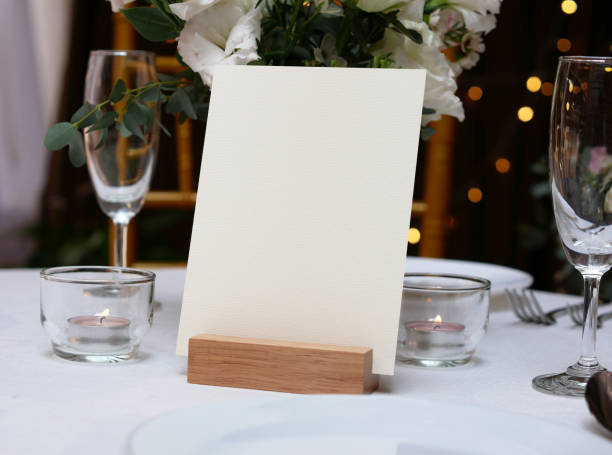 istock Mockup white blank space card, for greeting, table number, wedding invitation template on wedding table background. with clipping path 1309862061