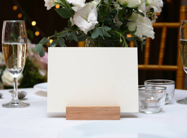 istock Mockup white blank space card, for greeting, table number, wedding invitation template on wedding table background. with clipping path 1309862067