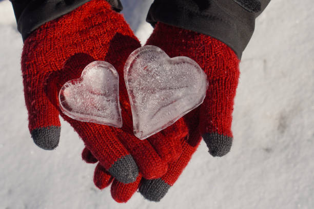 istock Heart snowball in woman´s hands 1309863106