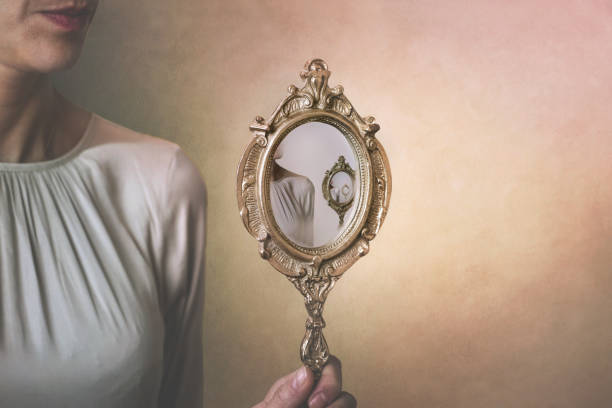 istock woman reflected in a mirror, surreal concept of looping oneself 1309863942