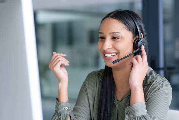 Sounds like she's making another big sale Shot of a young call centre agent working in an office headset stock pictures, royalty-free photos & images