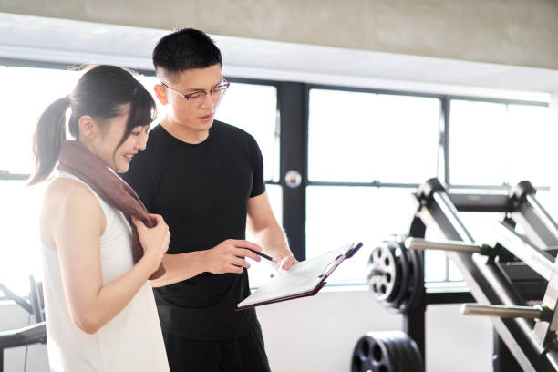 istock Asian male personal trainer giving training advice 1309864897