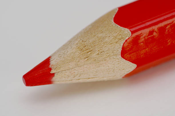 Red crayon shot up close on a white background