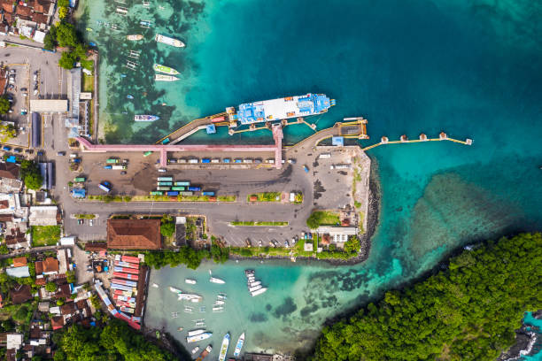 Top down view of the Padang Bai harbor in Bali, Indonesia, where trucks get out of a roro car ferry coming from Lombok stock photo