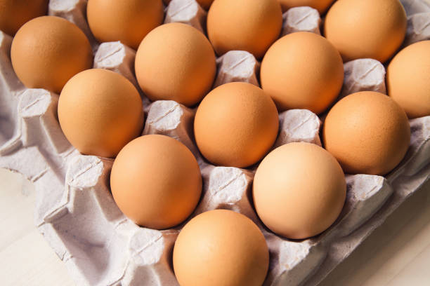 istock Chicken eggs in carton box close up. 1309866634