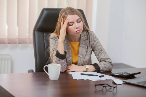 istock Tired lady boss sitting at table in office 1309866796