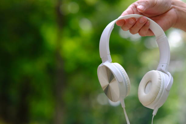 istock holding earphone on green background and space 1309867054