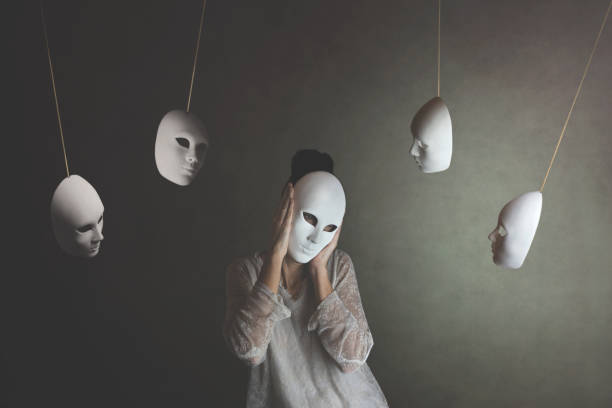 person with mask does not want to hear the judgment of other masks, concept of judgment and introspection stock photo