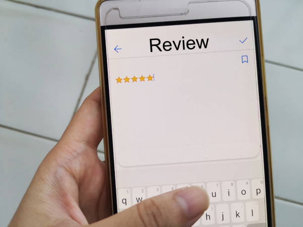 istock Customer Hands on Phone Giving Review For Yellow Five Stars, Customer Experience Satisfaction 1309867209