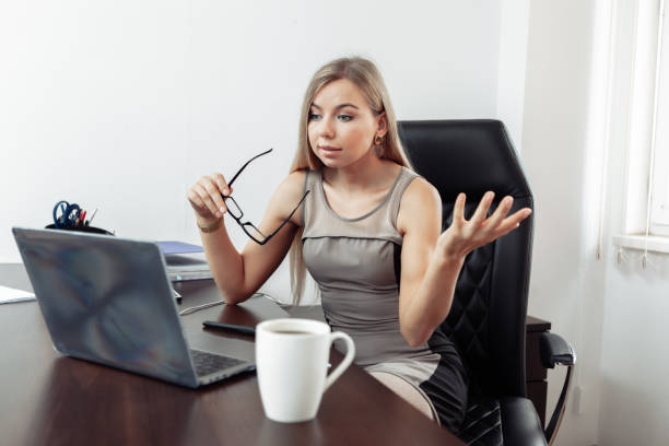 istock Online call. Business lady communicates emotionally by video call while looking at laptop in her home office 1309867964
