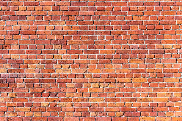 istock A wall of old, cracked bricks, with a weathered and faded surface. 1309868895