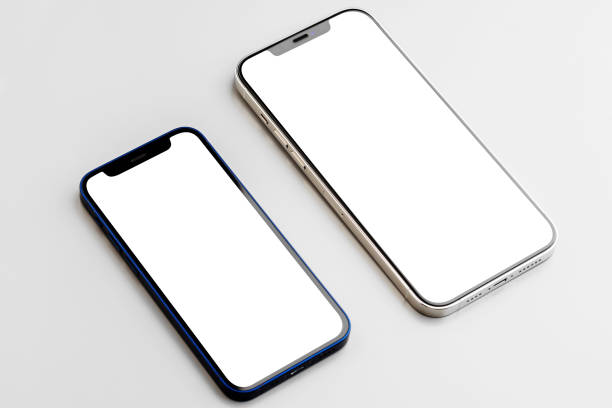 istock Two smartphones with blank white screen on gray background 1309870649