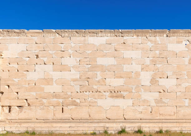 Greek marble stone wall background texture Vintage marble stone wall background texture, close-up under blue sky architectural exterior marble stone wall texture stock pictures, royalty-free photos & images