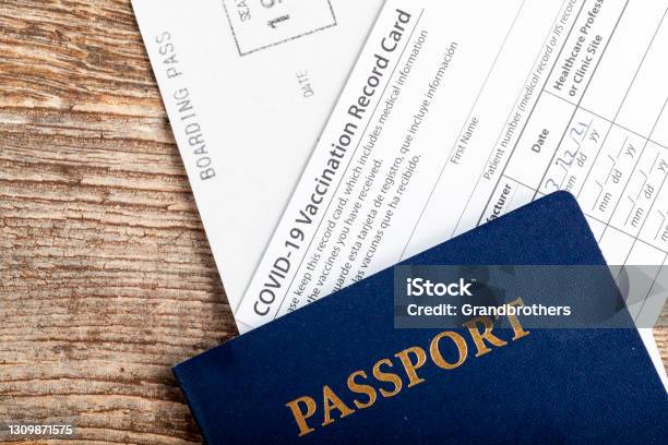 Flat Lay Top View Image Showing A Passport A Boarding Pass And A Covid19 Vaccination Record Card Proving That The Traveller Is Immune To Covid Stock Photo - Download Image Now