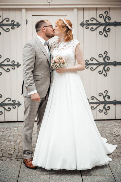 istock Groom and bride kissing on wedding day 1309873815