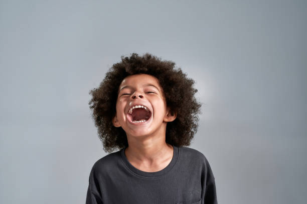 istock Cheerful little african american boy on light background 1309873982