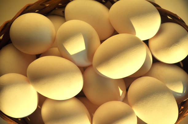 istock White chicken eggs in a basket. Top view 1309874194