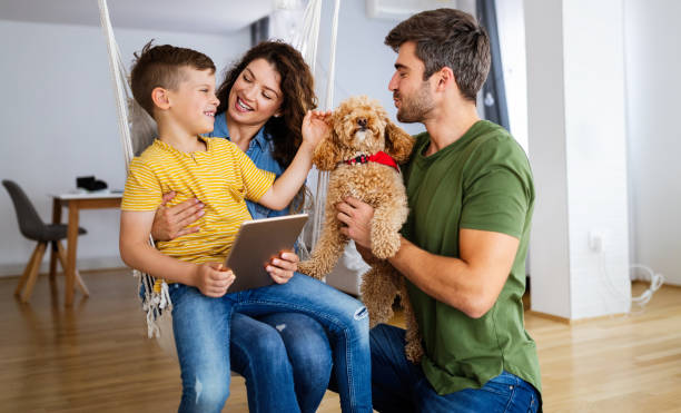 istock Happy family using technology devices together at home. 1309874347