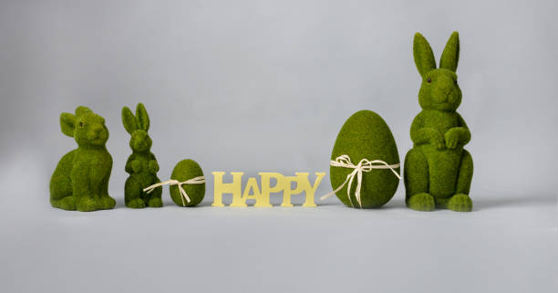 istock Easter composition with hare and eggs of green color on a gray background, place for text 1309874385