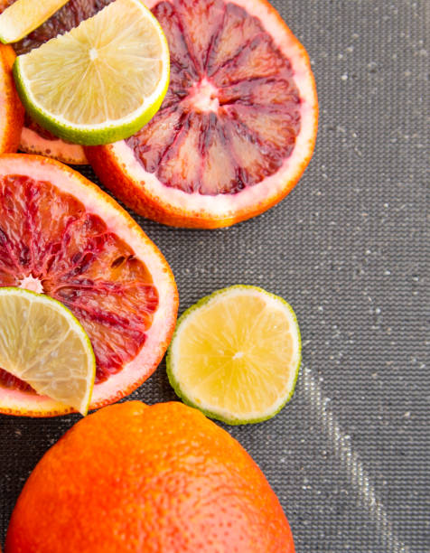 istock Red orange lime sliced and whole, on black background, close-up, copy space, template, postcard 1309875185