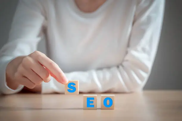 Text " SEO " on wooden block. concept for promoting website traffic, ranking, optimizing your website to rank in search engines or SEO.