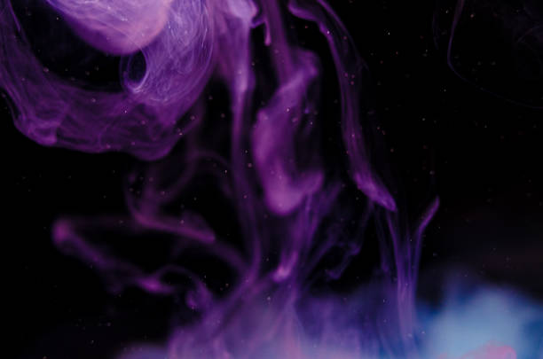 istock Ink swirls underwater. Ink cloud isolated on black background. Abstract effect of explosion of cosmos universe smoke with particles. 1309875615