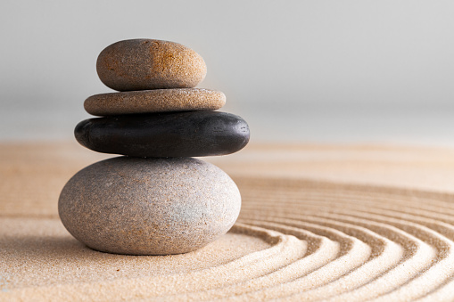 Japanese zen garden with stone in raked sand, close up.