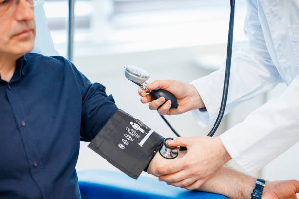 医師のオフィスで血圧を測定する男性 - 6006 ストックフォトと画像