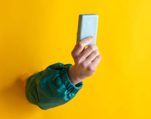 istock female hand hold soap on yellow background. 1309880427
