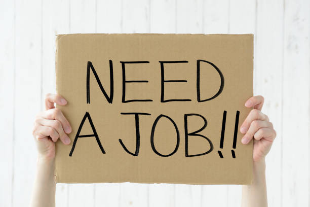 istock Human's hands raising cardboard with NEED A JOB word 1309881714