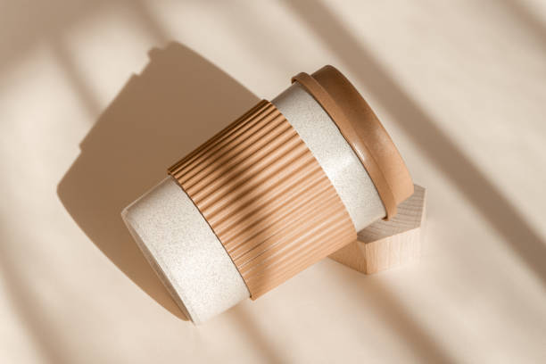 istock Bamboo eco friendly cup on natural shadow beige background. Reusable cup, biodegradable travel plastic coffee mug take away. Zero waste, sustainability concept. High angle view, sustainable 1309883090