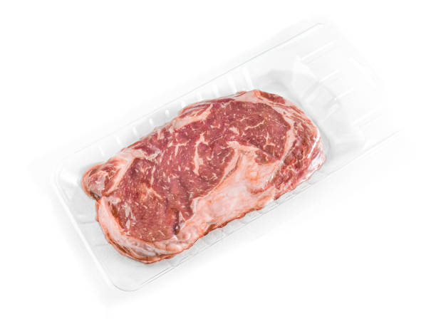 istock Marbled beef steak. Vacuum packed. View from above. White background. Isolated. 1309883248
