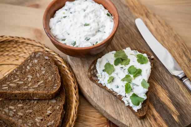 istock Butter and bread for breakfast, with parsley over rustic wooden background close up 1309883982