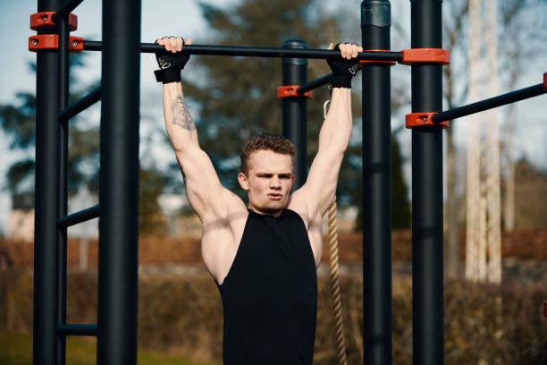 istock Body builder doing exercises outdoors 1309884662