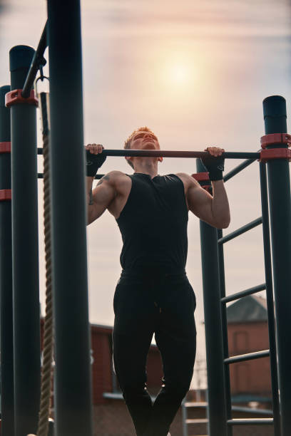 istock Body builder doing exercises outdoors 1309884734