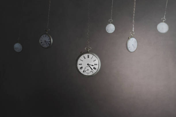 istock surreal moment with many pendulum clocks that mark several hours, business concept 1309884927