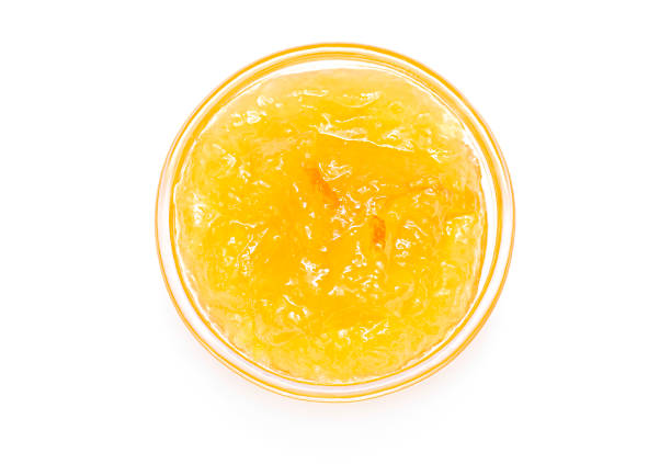 istock Orange jam in small glass bowl isolated on white 1309886061