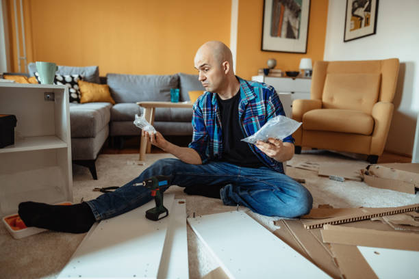 istock Man feels confused when assembling furniture with many parts 1309886474