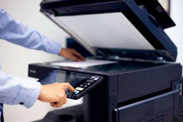 istock Bussiness man Hand press button on panel of printer, printer scanner laser in office copy machine supplies start concept. 1309887962