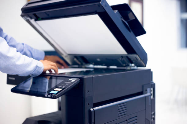 istock Bussiness man Hand press button on panel of printer, printer scanner laser in office copy machine supplies start concept. 1309887967