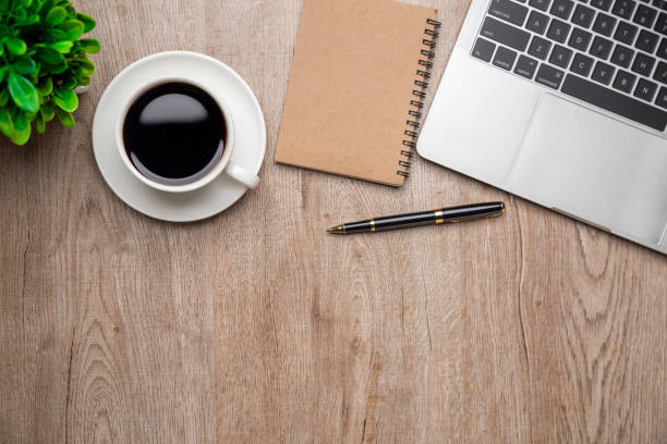 istock Flat lay, top view office table desk. Workspace with, laptop,office supplies, pencil, green leaf, and coffee cup on wood background. 1309888045