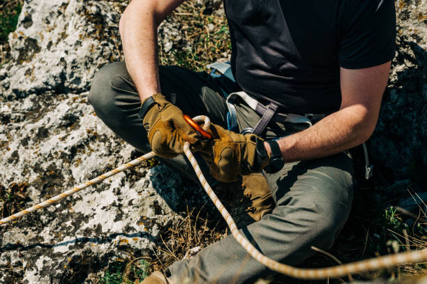 istock Man preparing rope in figure eight for rappelling 1309888579