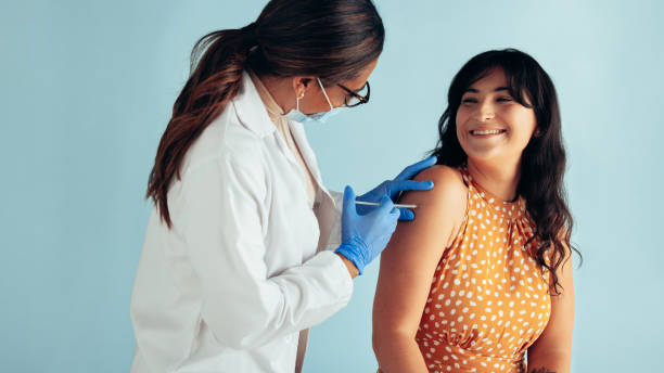 istock Woman getting flu shot from doctor 1309890334